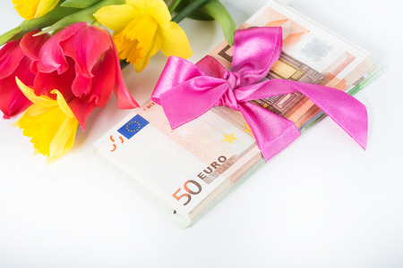 Stack of euro associated with a pink ribbonの写真素材