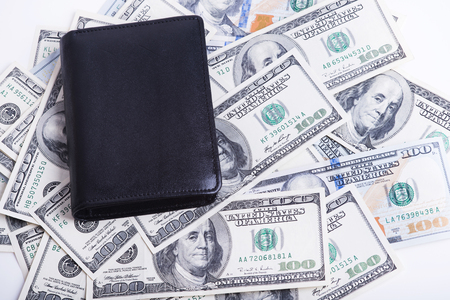 Stack of dollars in a black walletの写真素材