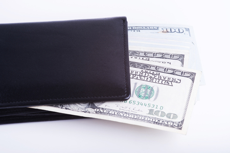 Stack of dollars in a black walletの写真素材