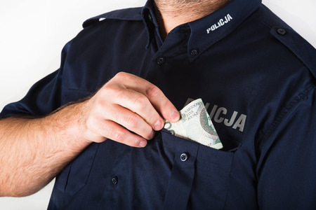 A corrupt policeman taking bribeの写真素材