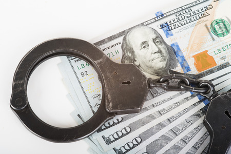 The photo dollars, handcuffs and gun.