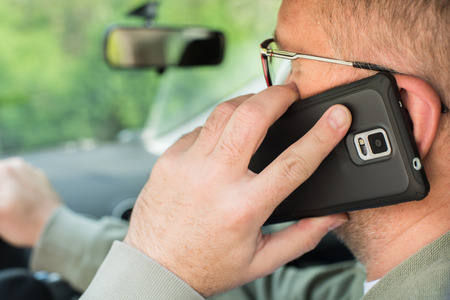 Man talking on the phone while driving