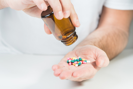 Man taking drugs. Drugs on hand.の写真素材