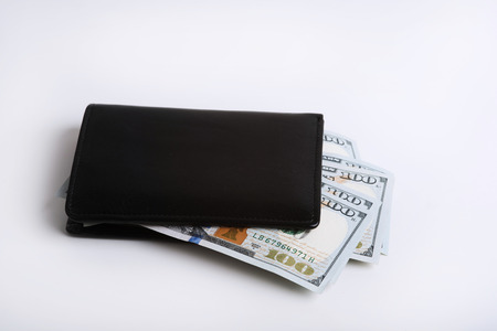 Stack of dollars in a black walletの写真素材