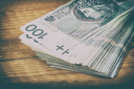 Polish currency PLN, money. File ,roll of banknotes of 100 PLN (Polish zloty)