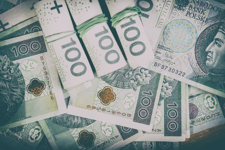Polish currency PLN, money. File ,roll of banknotes of 100 PLN (Polish zloty)の写真素材
