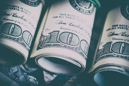 The US currency. Dollars related eraser on a wooden board.Background of successの写真素材