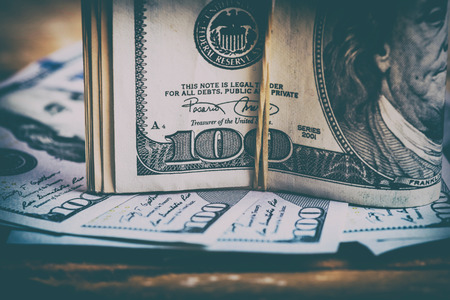 The US currency. Dollars related eraser on a wooden board.Background of successの写真素材