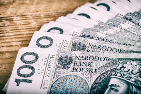 Polish currency PLN, money. File ,roll of banknotes of 100 PLN (Polish zloty)の写真素材