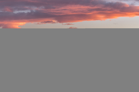 Russia, Karachaevo-Cherkessia. Fiery sunset in the winter in the mountains above Mount Elbrus and the Main Caucasian Ridge.の写真素材