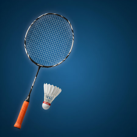 Professional studio shot of a modern badminton racket with an orange grip and a white shuttlecock. Isolated on a vibrant blue gradient backgroundの素材