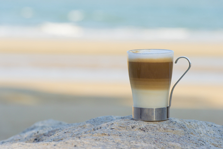 A cup of coffee  with sea at the backgroundの写真素材