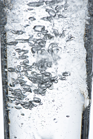 Closeup bubbles in the glass,water bubble,soda bubble on white backgroundの写真素材