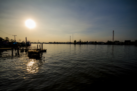 Fishing boat floating on the sea at dawn.の写真素材