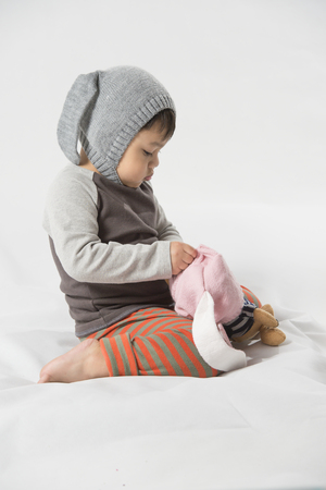 Cute baby boy with rabbit hat and white background.の写真素材