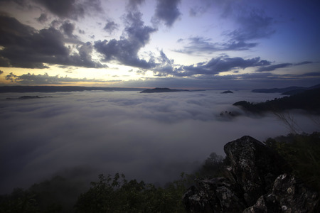 beautiful sunset in the mountains with fog and cloudsの写真素材