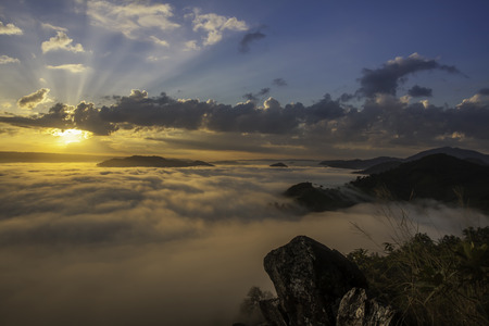 beautiful sunset in the mountains with fog and cloudsの写真素材