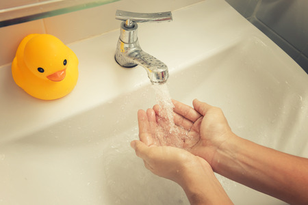 Washing your hands from the sink faucet.の写真素材