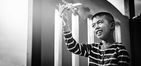 Asian boy playing with airplaneの写真素材