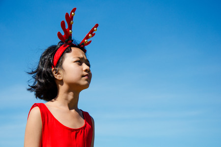 Portrait of Asian Kids Wearing Reindeer Headband on Outdoor.の写真素材