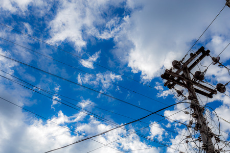 electricity post with cloud and blue skyの写真素材