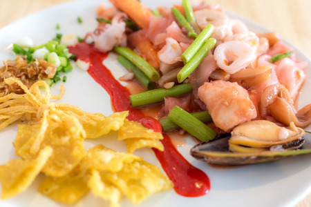Pink seafood flat noodles, morning glory, squid and vegetable, thai foodの写真素材