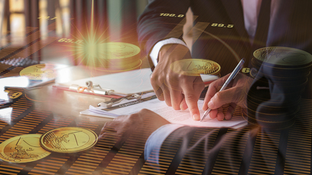 background of hand of businessman signing agreement and hand point to sign double exposure with gold...