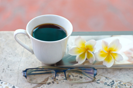 cafa espresso on old table flowers book spectacles.の写真素材