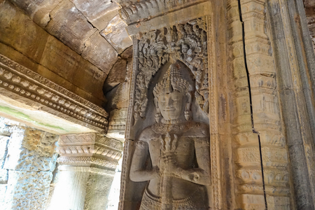 Carved by the wall of Bayon Temple at Angkor Thom.  On top view of the Angkor Thom within the temple area at the Angkor Temple complex  in a summer day near Siem Reap, Cambodia.の写真素材