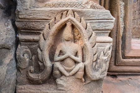 Carved statues along the wall of Bayon Temple at Angkor Thom.  On top view of the Angkor Thom within the temple area at the Angkor Temple complex  in a summer day near Siem Reap, Cambodia.の写真素材