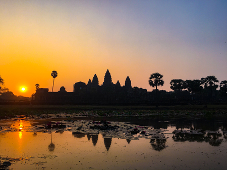 Silhouette Angkor Wat Temple with Rising Sun. Best time in the morning a popular view tourist attraction ancient temple complex Silhouette Angkor Wat with reflected in lake Siem Reap, Cambodia.の写真素材