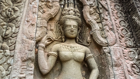 Statue carved on the wall of Bayon Temple at Angkor Thom.  On top view of the Angkor Thom within the temple area at the Angkor Temple complex  in a summer day near Siem Reap, Cambodia.の写真素材