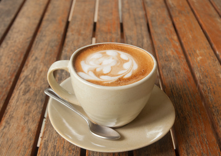 coffee latte art on wood table in coffee shop.
