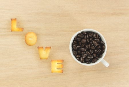 alphabet love on wood table and coffee cup pastel filter effect.の写真素材
