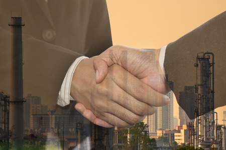 Double exposure business man handshake and partnership oil industry concept.の写真素材