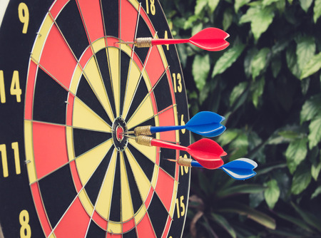 Dart is a competition and opportunity. Dartboard is be like as the target center and goal of business. therefor Bulls eyes of Dart board is both challenge,success,risk management,goal,opportunity.の写真素材