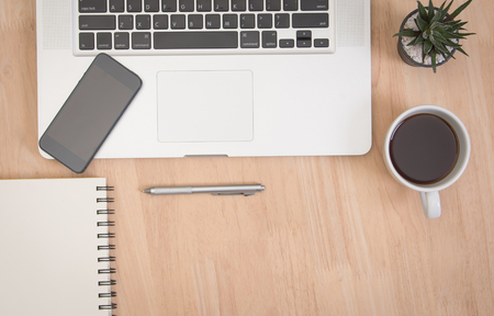 Business's desk of office supplies and gadgets computer, telephone, pen, book, cactus on empty wooden table background. Top View from above.のeditorial素材