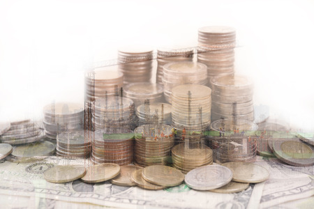 pile coin money with dollar bills construction finance and banking concept for background.
