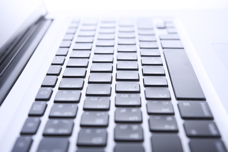 Close up computer keyboard on desktop office of a modern laptop.