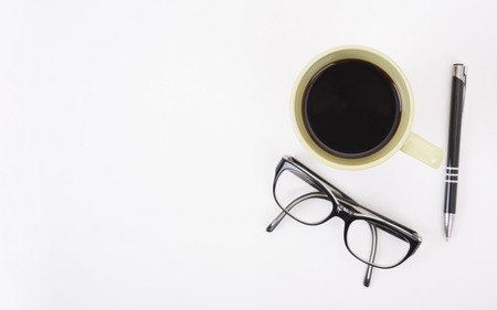 Modern Office desk with eyeglasses, pen,  and coffee cup.Top View table from above with copy space for input the text.の写真素材