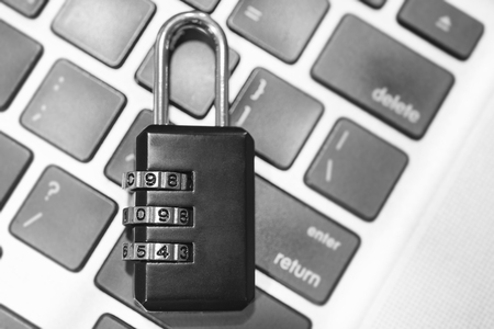 Closeup padlock on computer keyboard for concept technology data log security.