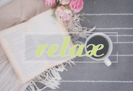 relax text and coffee cup of hot drink and a book on gray carpetの写真素材