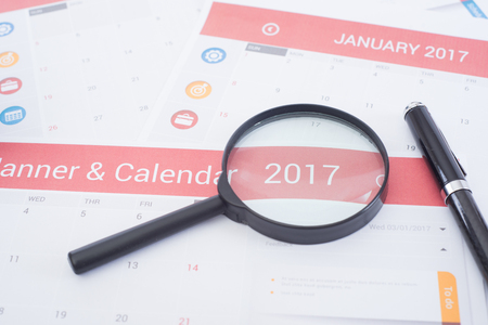 magnifier and business Calender Planner 2017 on desk office. organization management remind concept.の写真素材