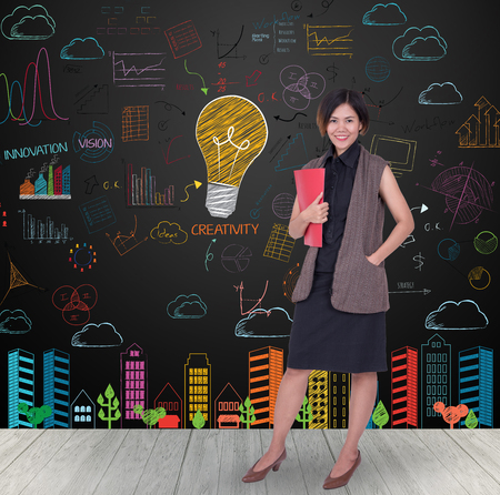 businesswomen holding red file with colorful light bulb and startup sketch drawn on wall. Concept of idea of businessの写真素材