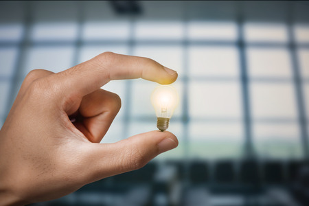 Business hand holding light bulb. concept of new ideas with innovation and creativity.の写真素材