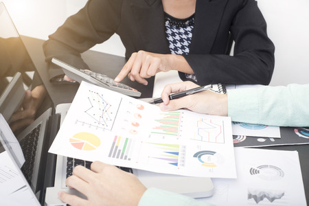 business accountants with documents graph financial on office table. concept planning budget and audit.の写真素材