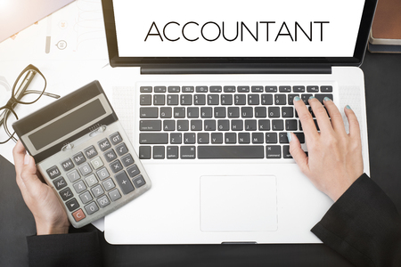 business accountant with document graph financial and calculator on office table. concept planning budget and audit.の写真素材