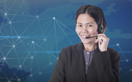 Asia women happy smiling customer support operator with headset on telecom network background.の写真素材