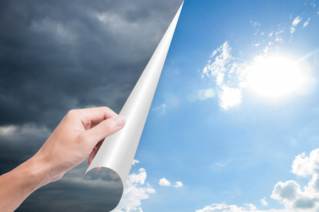 hand opening page overcast to bright blue sky. concept hope inspirationの写真素材