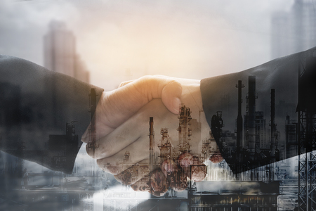 Double exposure business worker with graph finance and factory construction. concept success investment.の写真素材